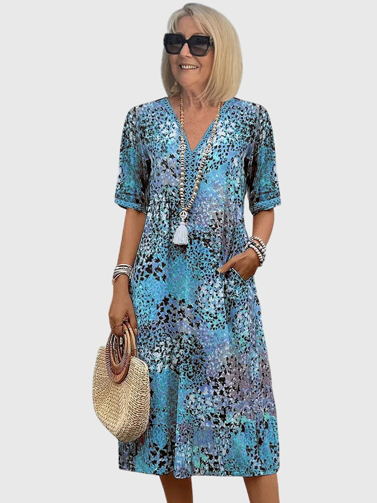 Floral midi dress featuring a chic design and breathable fabric, perfect for elegant and versatile styling in any season. 2