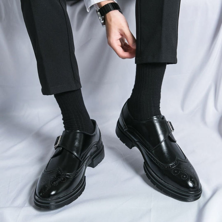 Men's dress shoes featuring elegant wingtip brogue detailing and a stylish single buckle closure, crafted in a sophisticated leather look, perfect for formal occasions. 0