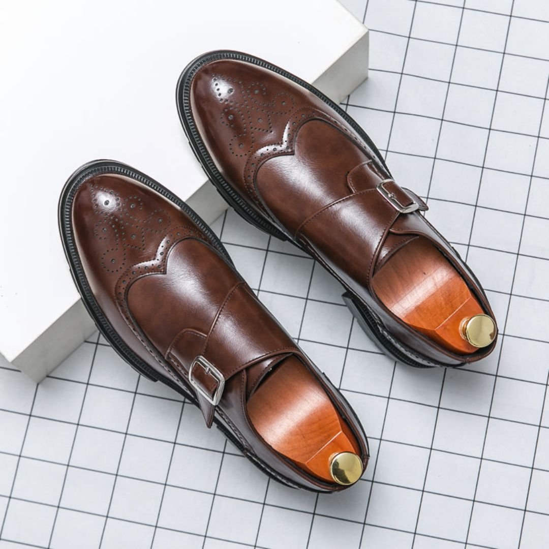 Men's dress shoes featuring elegant wingtip brogue detailing and a stylish single buckle closure, crafted in a sophisticated leather look, perfect for formal occasions. 4
