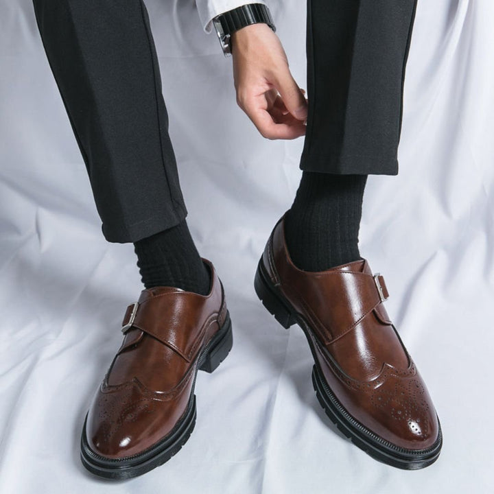 Men's dress shoes featuring elegant wingtip brogue detailing and a stylish single buckle closure, crafted in a sophisticated leather look, perfect for formal occasions. 5