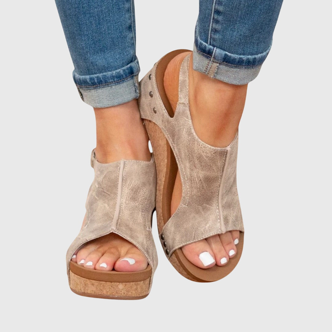 Orthopedic sandals featuring a cushioned insole, adjustable buckle, and lightweight wedge design, perfect for all-day comfort and support. 1