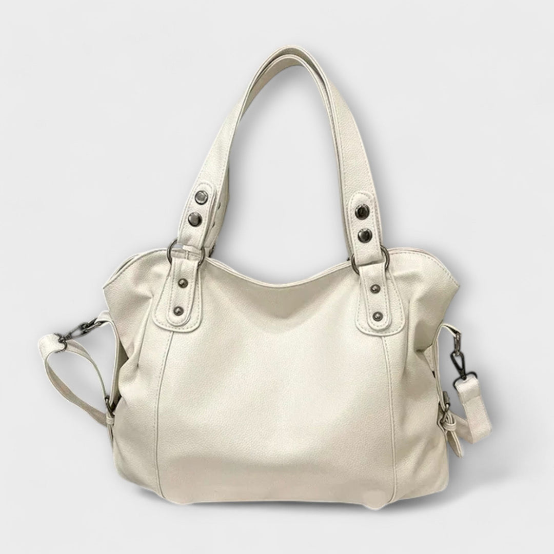 Vegan leather shoulder bag featuring an adjustable strap, multiple compartments, and a spacious design for versatile use as a large capacity tote. 0