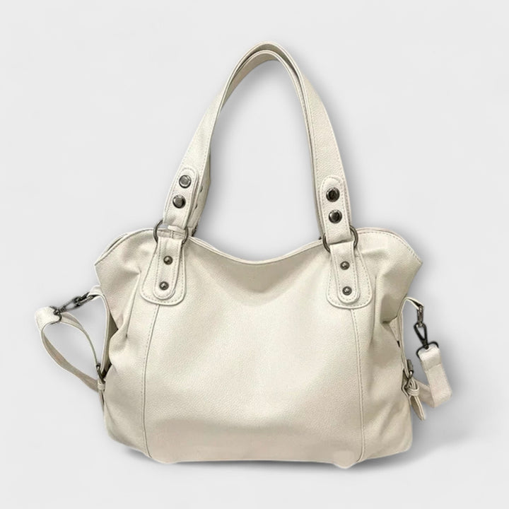 Vegan leather shoulder bag featuring an adjustable strap, multiple compartments, and a spacious design for versatile use as a large capacity tote. 0
