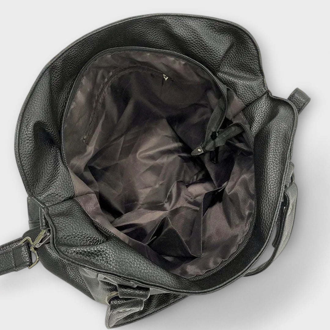 Vegan leather shoulder bag featuring an adjustable strap, multiple compartments, and a spacious design for versatile use as a large capacity tote. 4
