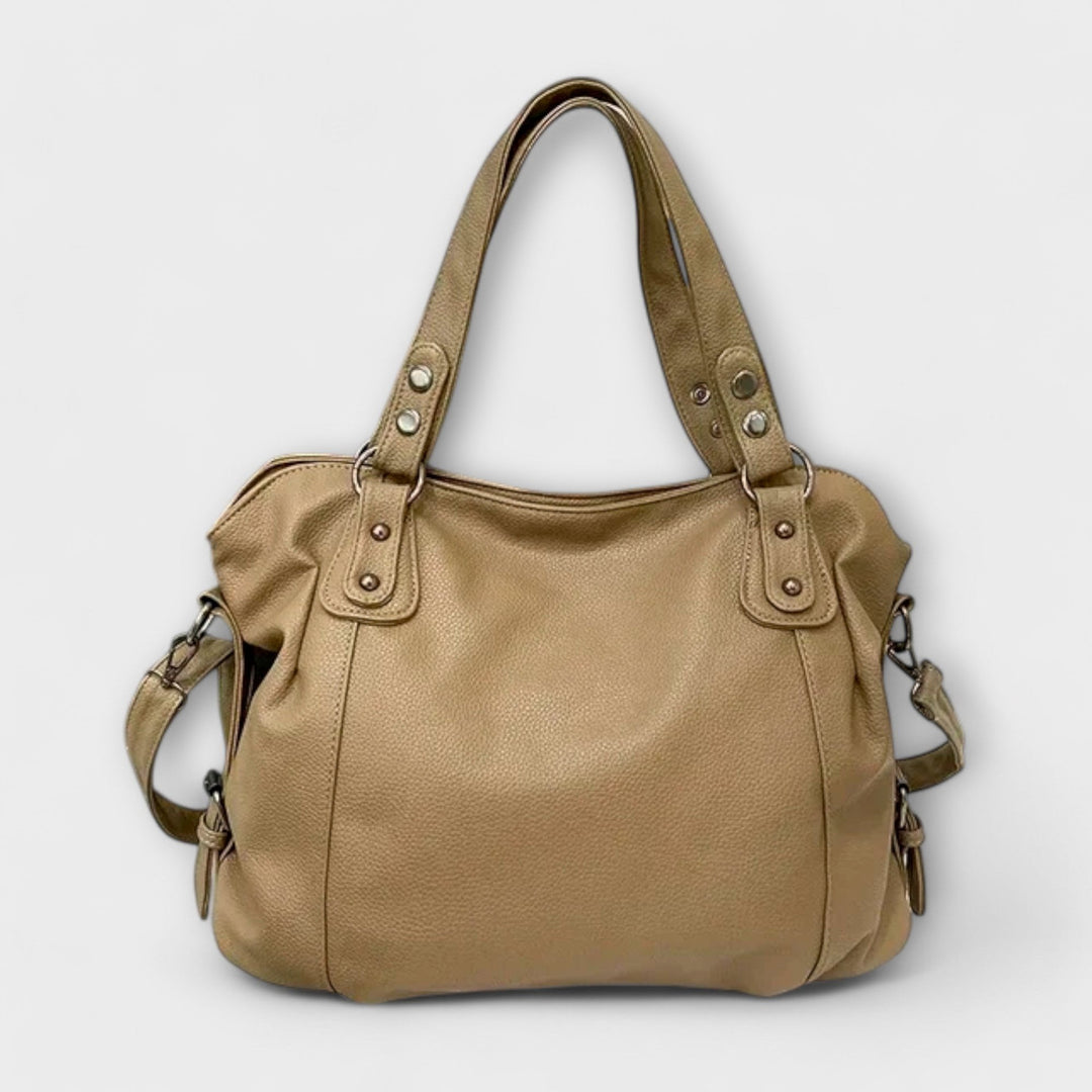 Vegan leather shoulder bag featuring an adjustable strap, multiple compartments, and a spacious design for versatile use as a large capacity tote. 7