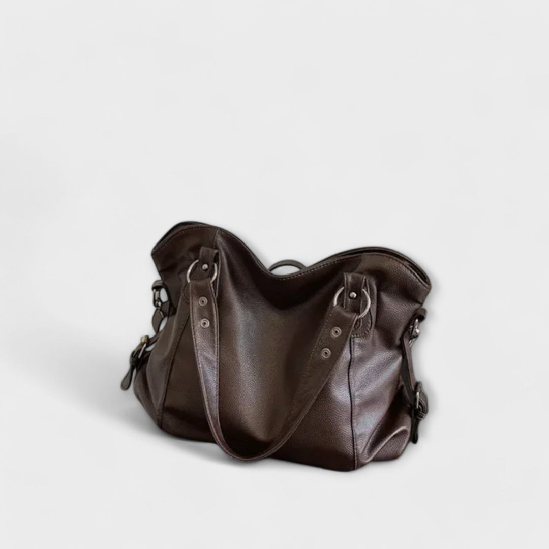 Vegan leather shoulder bag featuring an adjustable strap, multiple compartments, and a spacious design for versatile use as a large capacity tote. 8