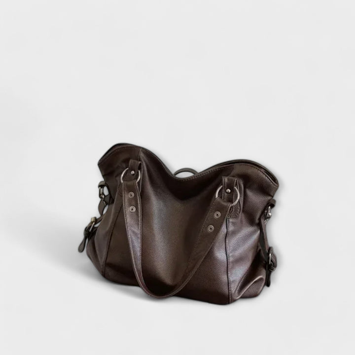 Vegan leather shoulder bag featuring an adjustable strap, multiple compartments, and a spacious design for versatile use as a large capacity tote. 8