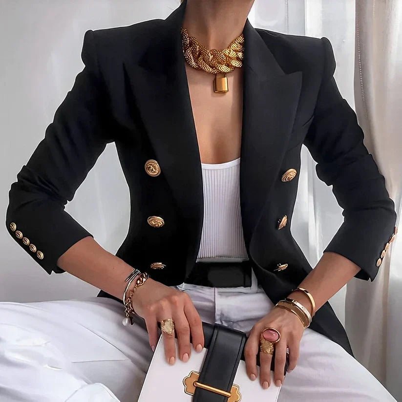 Women's double-breasted blazer featuring gold buttons and a structured fit, available in black and white options, perfect for professional or casual wear. 0