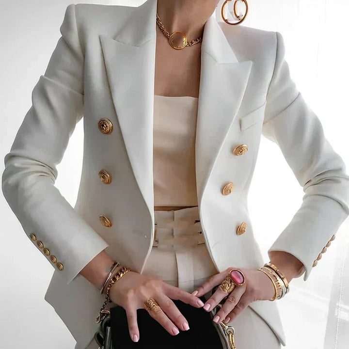Women's double-breasted blazer featuring gold buttons and a structured fit, available in black and white options, perfect for professional or casual wear. 1