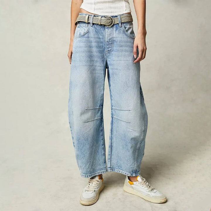 Women's mid-rise cropped barrel leg jeans in heavyweight denim featuring panel-stitched durability, styled in a medium-fade wash. 0