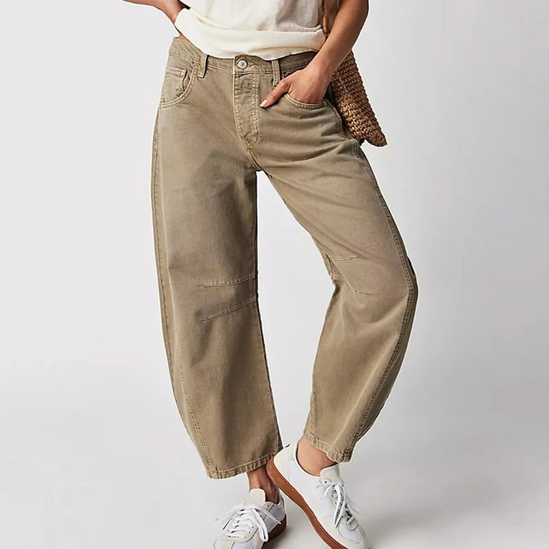 Women's mid-rise cropped barrel leg jeans in heavyweight denim featuring panel-stitched durability, styled in a medium-fade wash. 11
