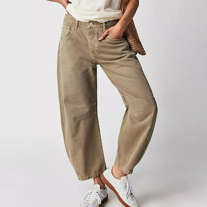 Women's mid-rise cropped barrel leg jeans in heavyweight denim featuring panel-stitched durability, styled in a medium-fade wash. 11