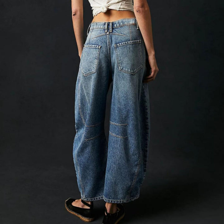 Women's mid-rise cropped barrel leg jeans in heavyweight denim featuring panel-stitched durability, styled in a medium-fade wash. 7