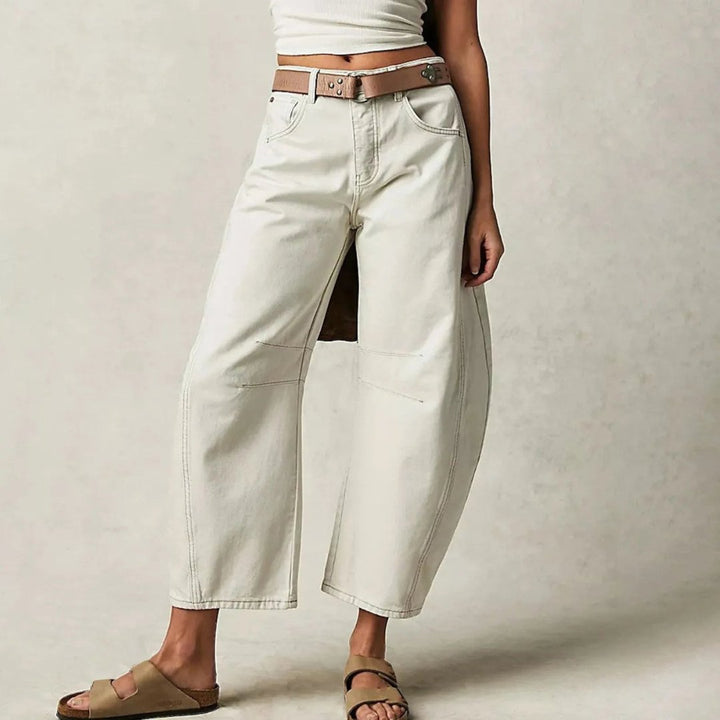 Women's mid-rise cropped barrel leg jeans in heavyweight denim featuring panel-stitched durability, styled in a medium-fade wash. 9