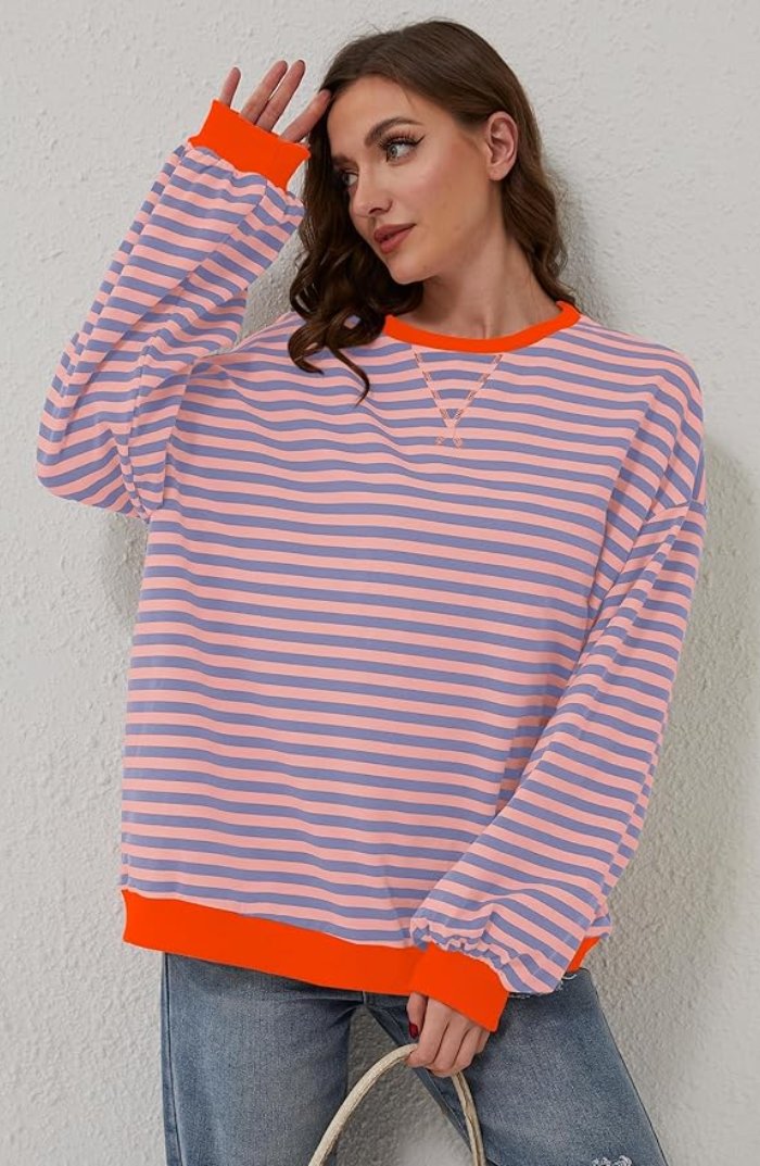 Women's oversized sweatshirt featuring a striped drop-shoulder design with neon contrast trim, made from lightweight knit fabric for comfortable, stylish wear. 4