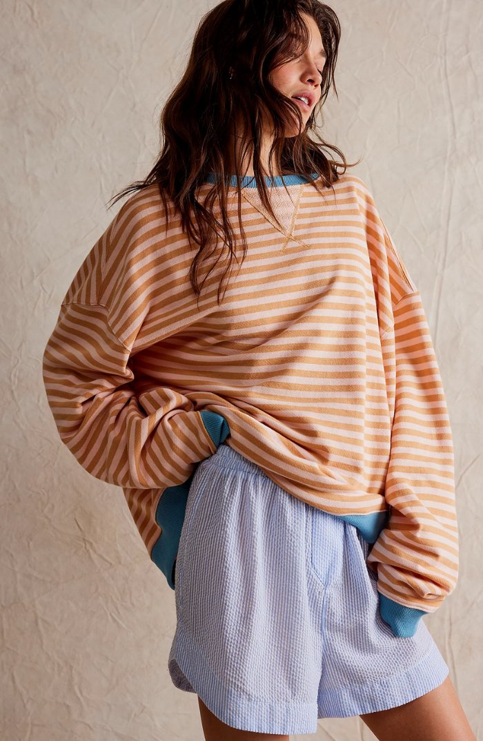 Women's oversized sweatshirt featuring a striped drop-shoulder design with neon contrast trim, made from lightweight knit fabric for comfortable, stylish wear. 6