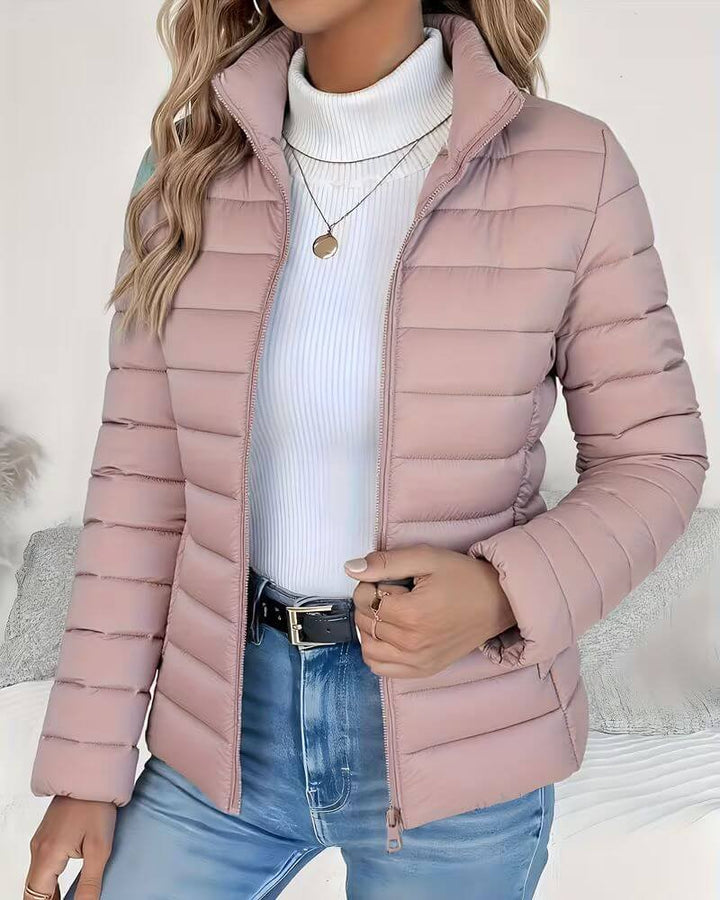 Lightweight women's puffer jacket with a stand collar, featuring a quilted design and hip-length cut, perfect for winter wear. 3