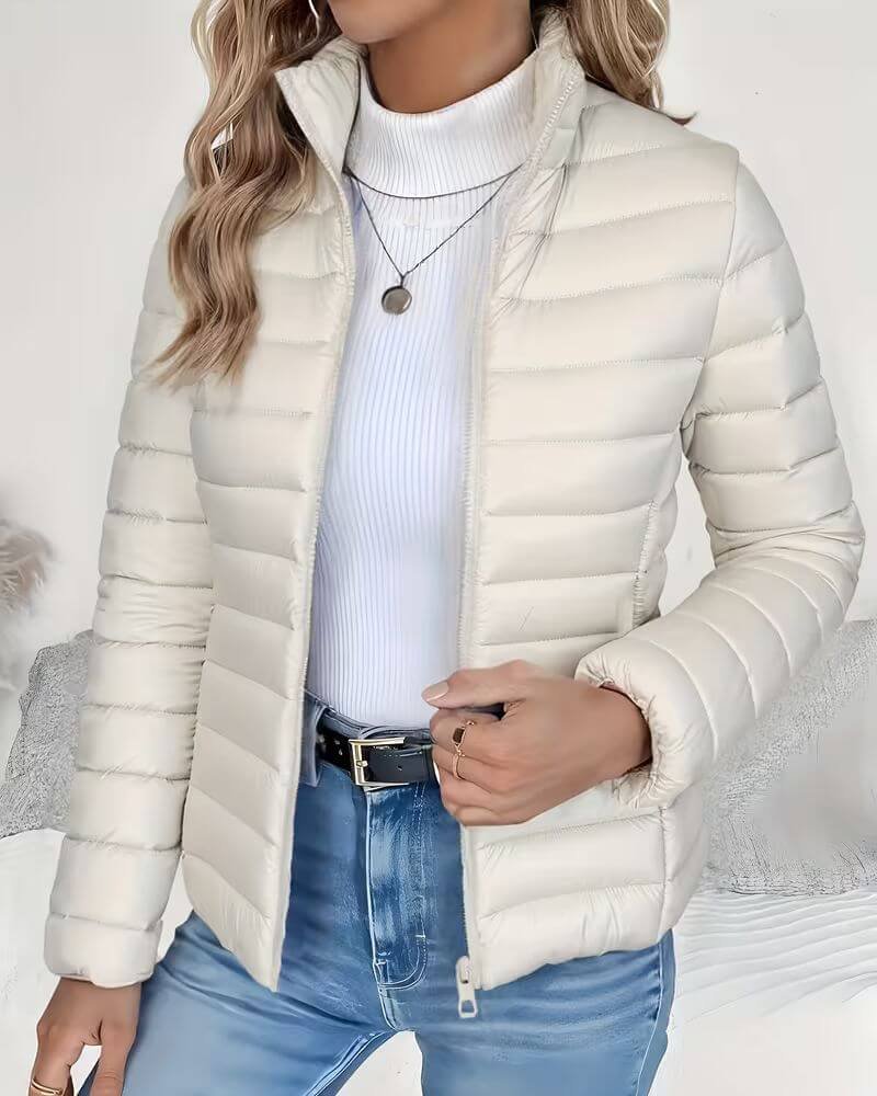 Lightweight women's puffer jacket with a stand collar, featuring a quilted design and hip-length cut, perfect for winter wear. 4
