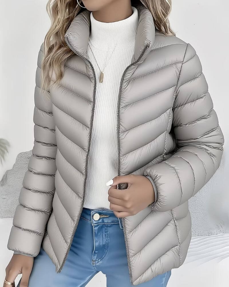 Lightweight women's puffer jacket with a stand collar, featuring a quilted design and hip-length cut, perfect for winter wear. 5