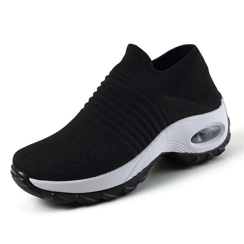 Women's slip-on sneakers featuring air cushion technology and a breathable knit design, perfect for all-day comfort and style. 3
