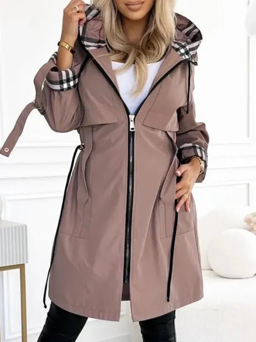 Women's waterproof trench coat featuring a windproof design and tailored fit, ideal for all weather conditions, with a stylish hood for added protection. 0
