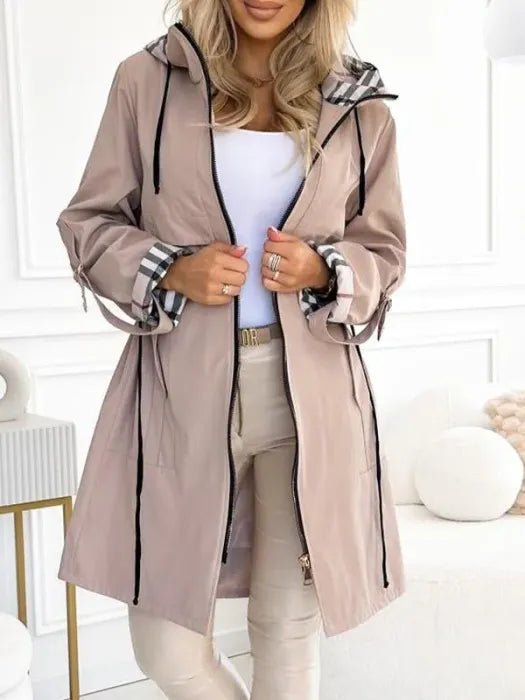 Women's waterproof trench coat featuring a windproof design and tailored fit, ideal for all weather conditions, with a stylish hood for added protection. 1