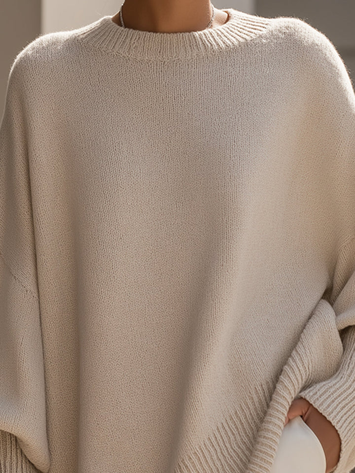 Wool blend oversized sweater with asymmetrical hem, featuring a cozy and elegant design, perfect for stylish layering in cooler weather. 1
