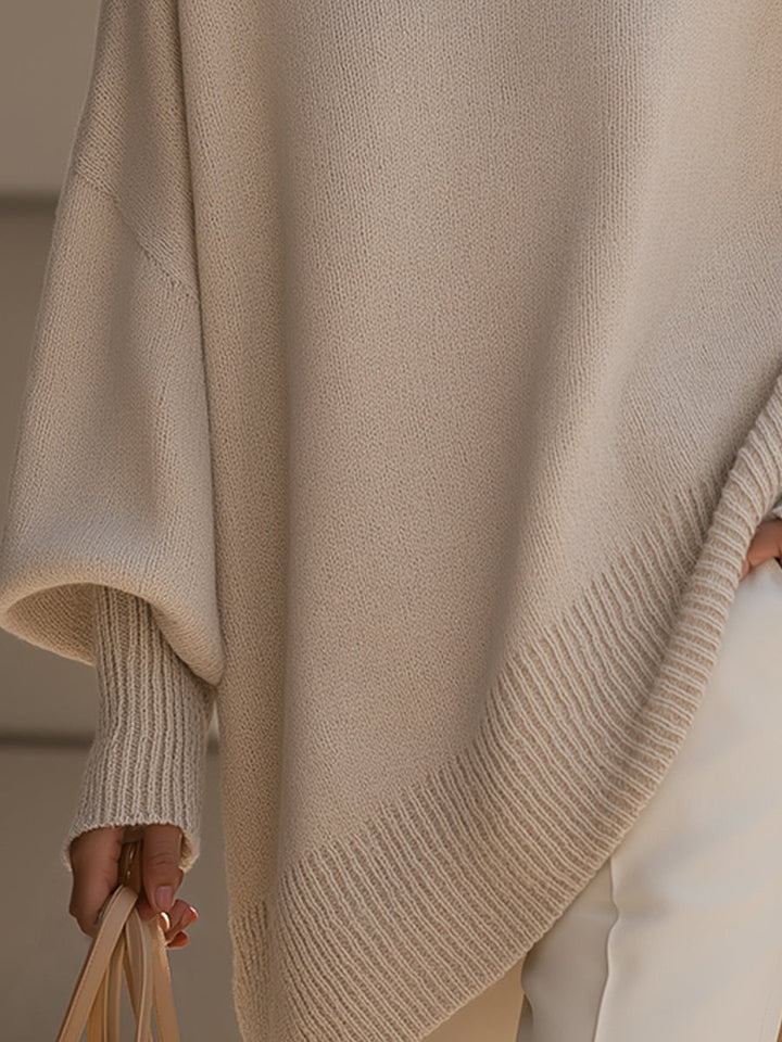 Wool blend oversized sweater with asymmetrical hem, featuring a cozy and elegant design, perfect for stylish layering in cooler weather. 2