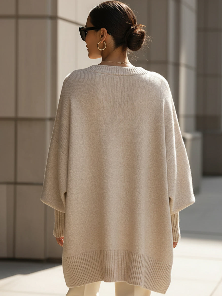 Wool blend oversized sweater with asymmetrical hem, featuring a cozy and elegant design, perfect for stylish layering in cooler weather. 3